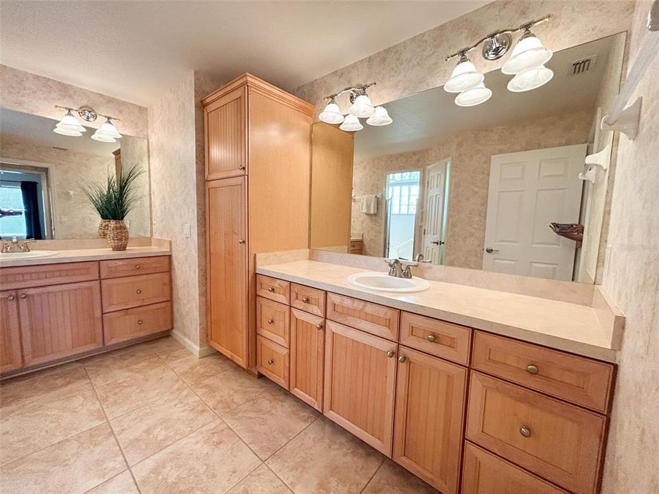 Primary Bathroom with double vanities, beautiful wood cabinets and huge walk in shower