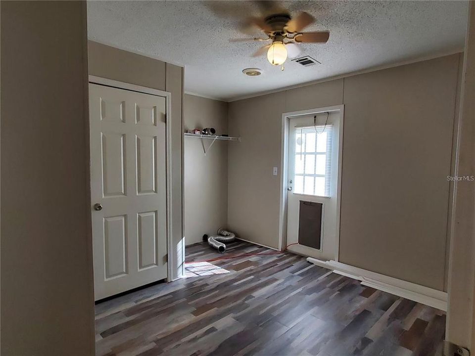 Laundry room with closet