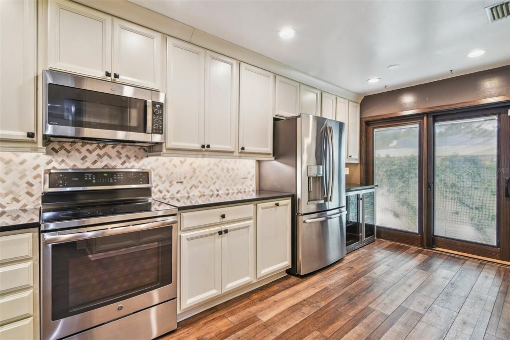 Start your tour in the UPDATED KITCHEN offering a comfortable layout with tons of storage, STAINLESS STEEL APPLIANCES, sliding glass door access to a private COURTYARD PATIO and the pass through breakfast bar keeps you seamlessly connected to the main living area.