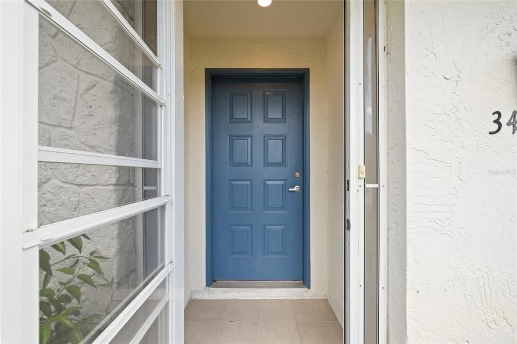 Screened in door leads to front door.