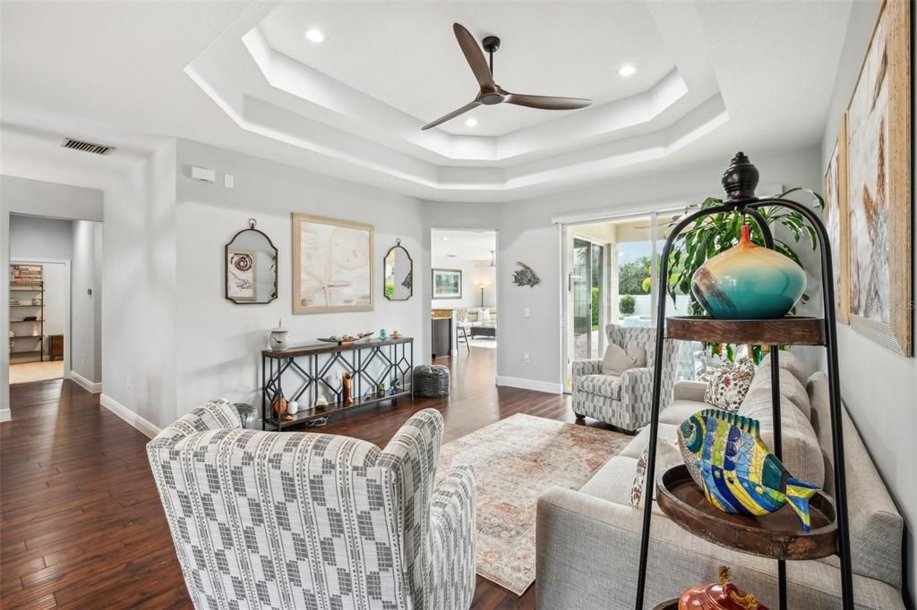 Beautiful wood floors greet you as you step through the front door and into the foyer that opens up to formal living and dining spaces with sliding glass door access to the lanai for great light and the perfect place to gather with family or entertain friends.