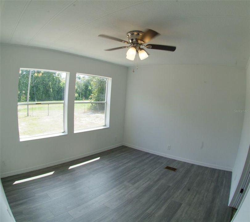 Master Bedroom with 2 windows, ceiling fan, and laminate flooring