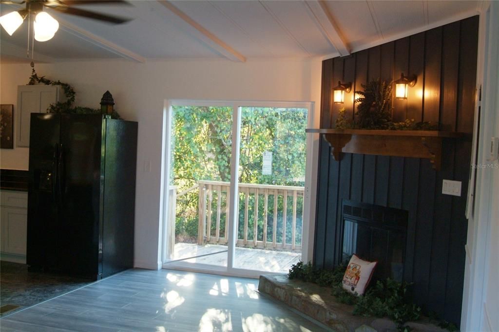 View out sliding glass door to rear deck and backyard