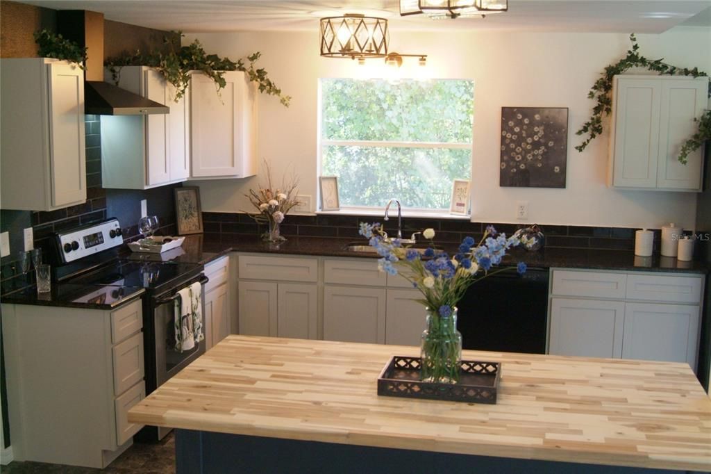 Custom Wood Butcher Block Countertop on Custom Trimmed Island with Barstool Seating