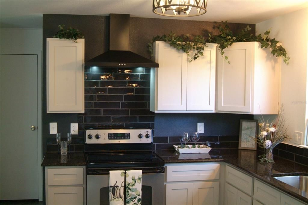 Kitchen Closeup with Custom Tile Backsplash and Vent Hood