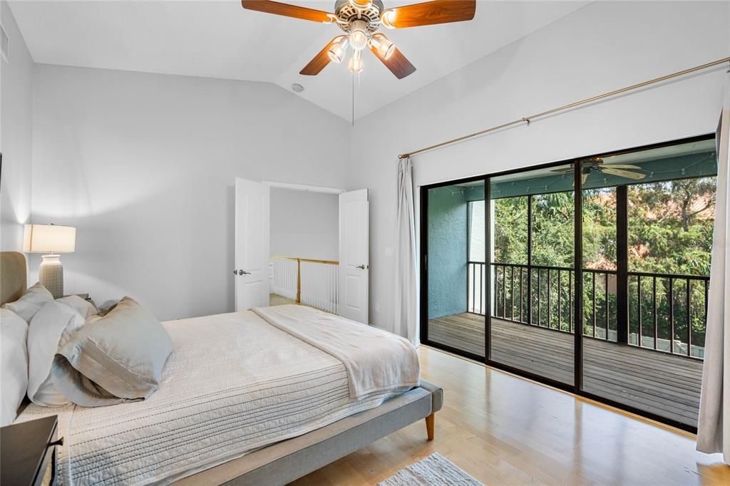 Large primary bedroom with private screened in balcony