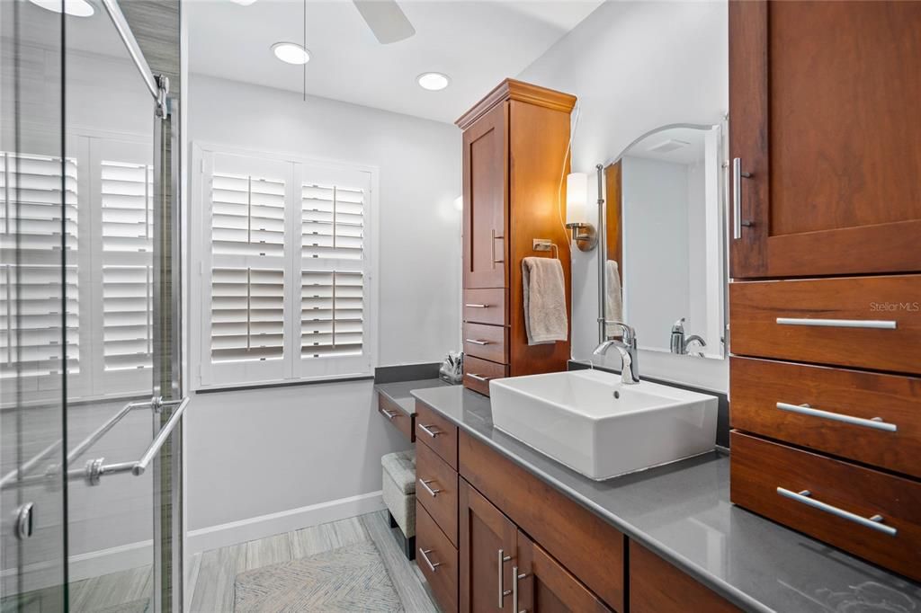 Primary bathroom with lots of storage from built-in cabinetry & vanity