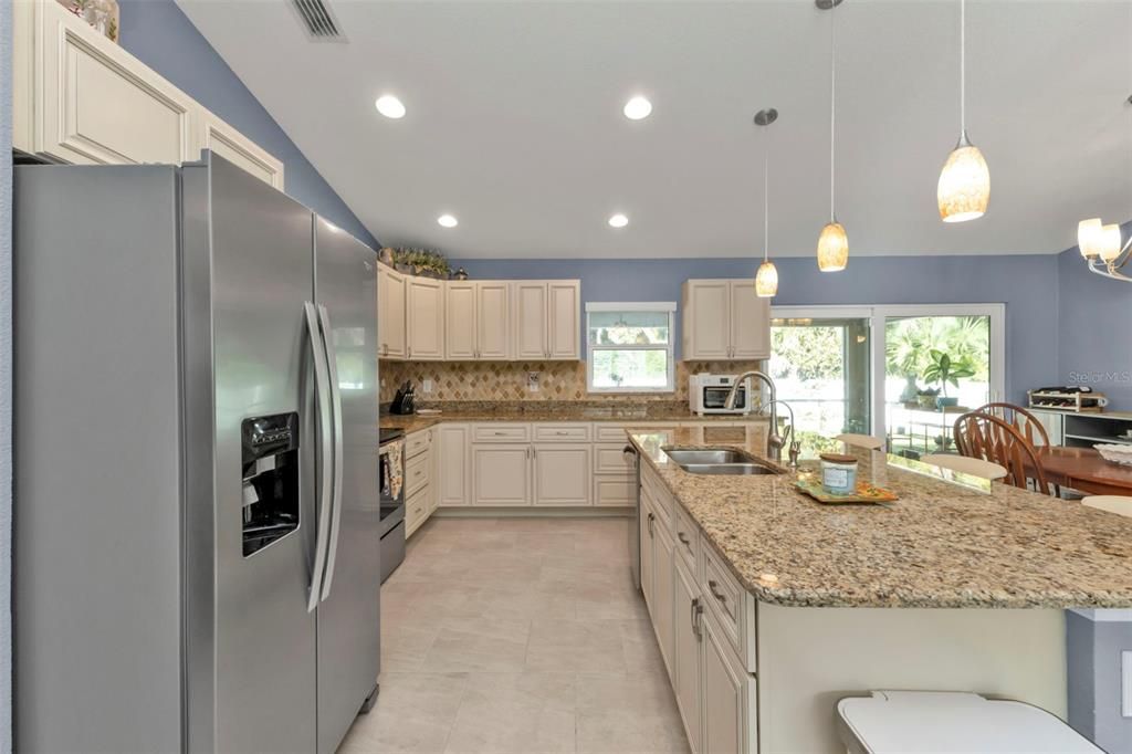 Recessed lighting, double stainless steel sink and beautiful wood cabinetry.