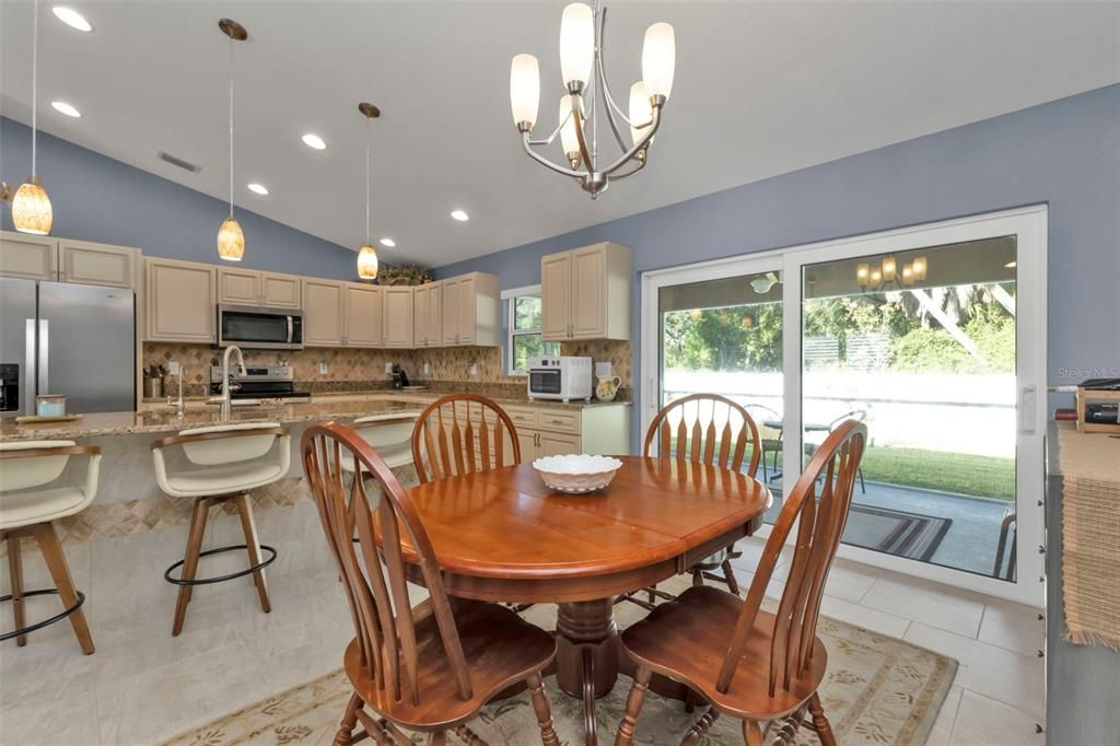 Dining area opens up to beautiful kitchen.