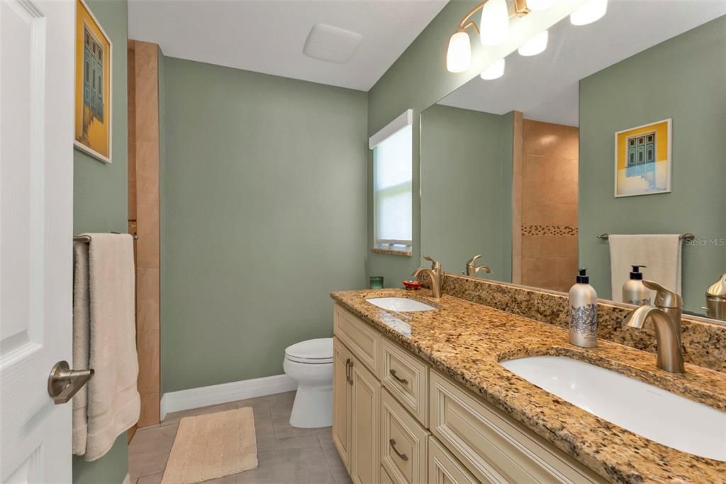 Master bathroom with dual sinks, granite counter top and walk in shower.