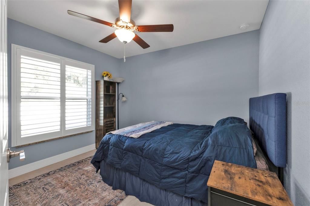 Guest bedroom 3  features porcelain tile flooring, ceiling fan and closet.