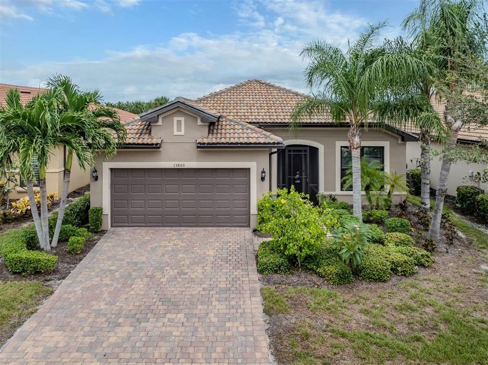 Paver drive and screened front entrance is so inviting