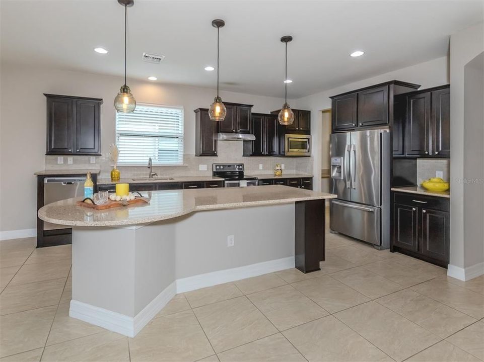 Granite Counter tops and solid wood cabinetry complete this kitchen