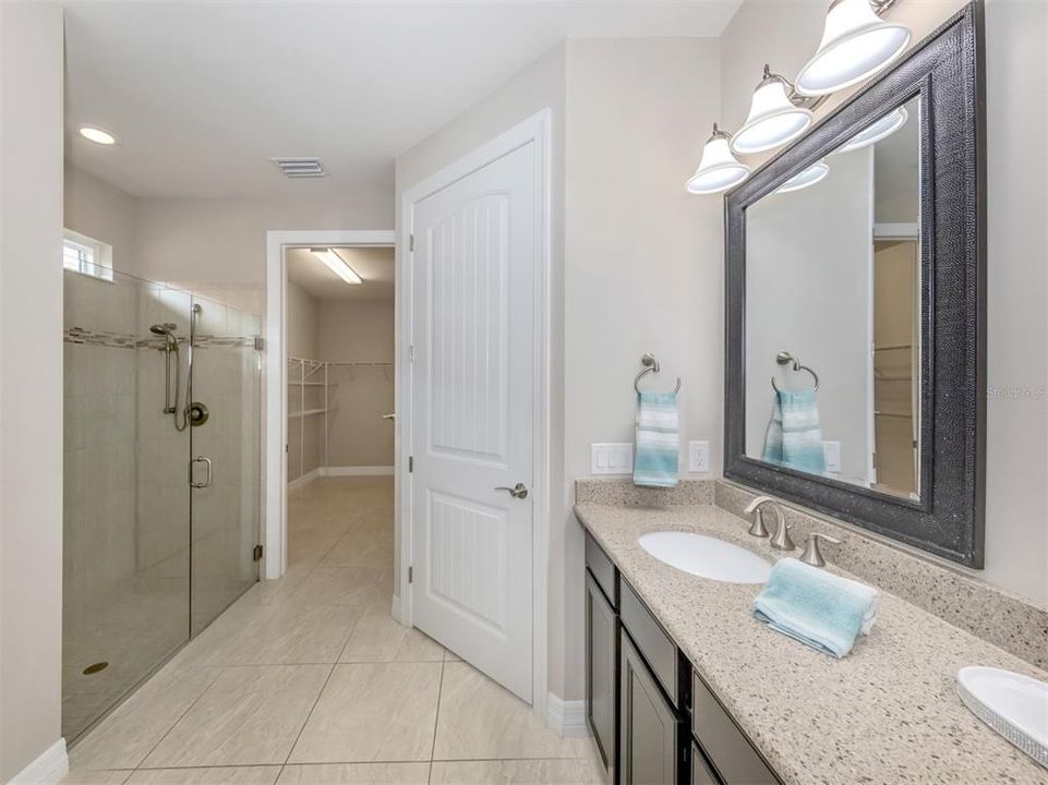 Glass shower, dual sinks and private water closet in the master ensuite