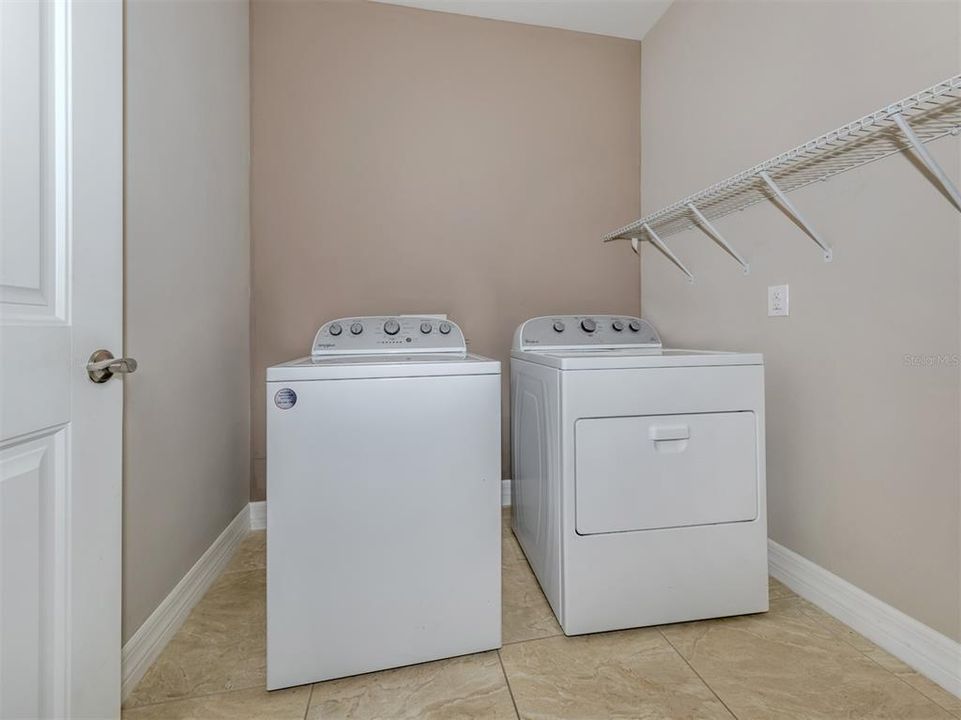 The laundry room offers plenty of room for delicates and storage