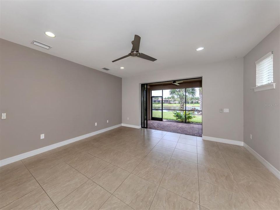 The great room is spacious and overlooks the lanai and beautiful water