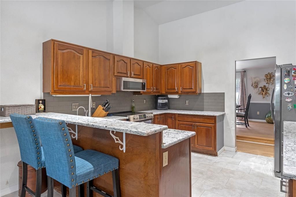 Kitchen with granite counters & stainless steel appliances