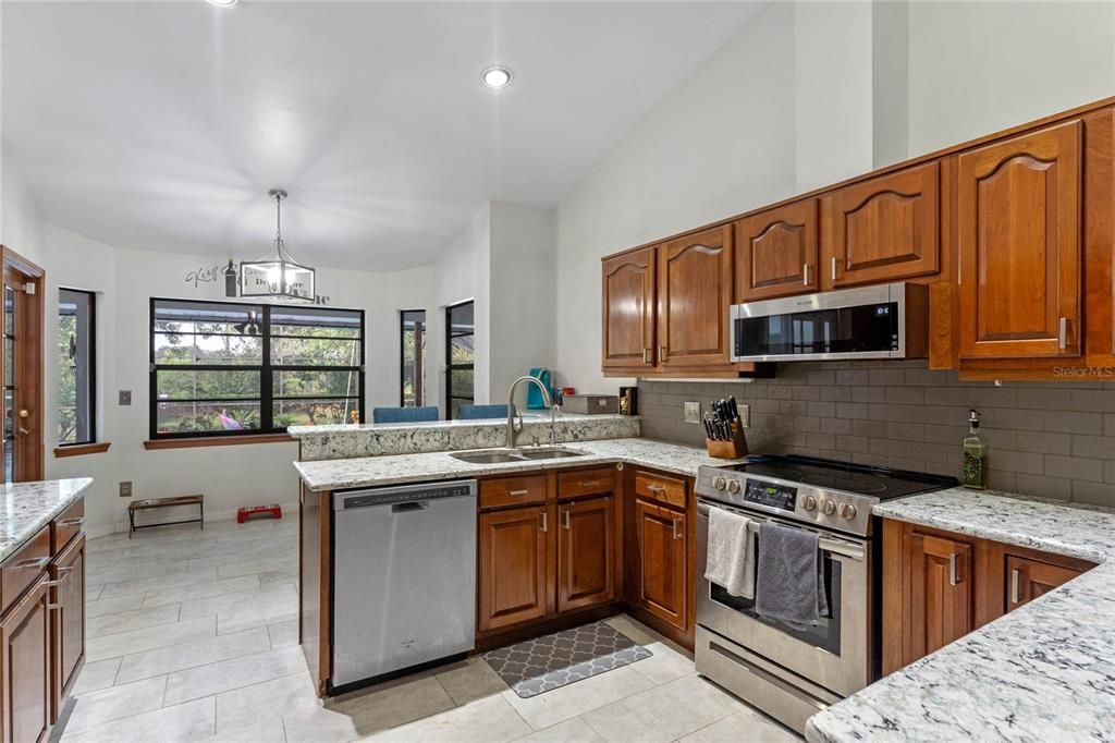 Kitchen with granite counters & stainless steel appliances