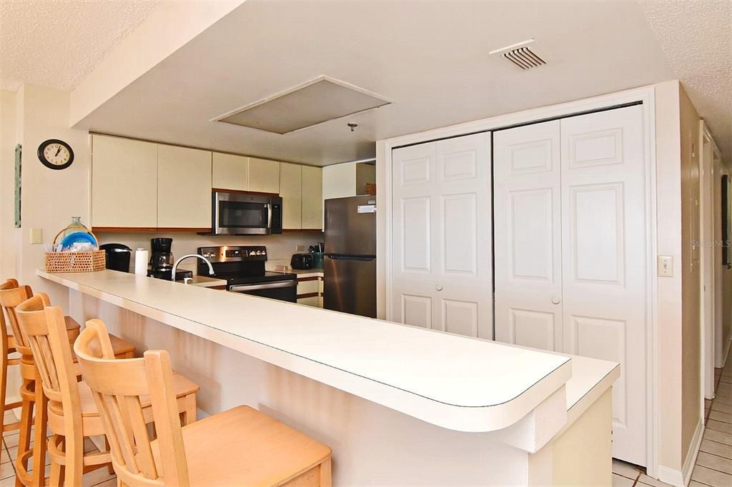 Kitchen Pic 2 showing  Bar with chairs