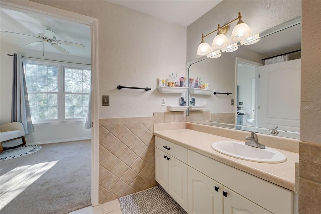 The bathroom opens up to both the front hallway and the bedroom.