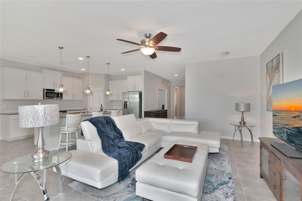 Great room layout with neutral tile floors.