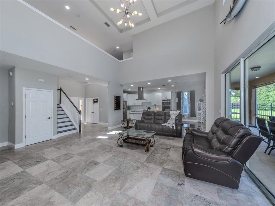 Spacious great room design with sliding glass door access to the lanai and powder room