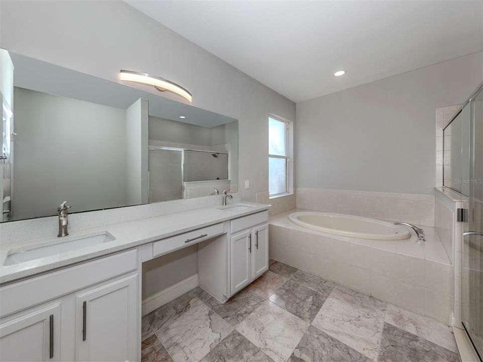 The spa like master bath is perfect with dual sinks, make up counter, garden tub, and walk in shower