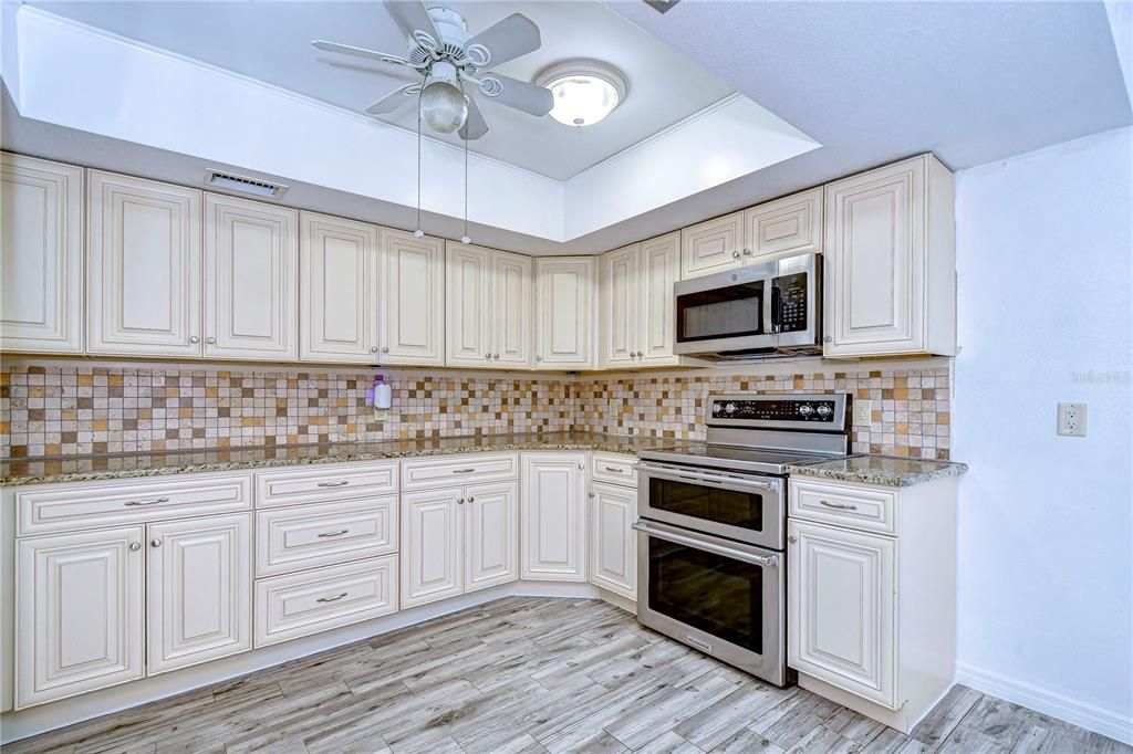 Granite countertops, sleek stainless appliances and stylish tile backsplash!