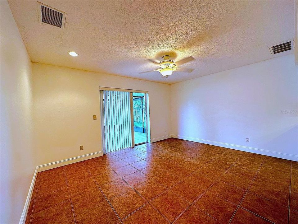 To the right of the family room enter the dining room which leads out to the screened back patio