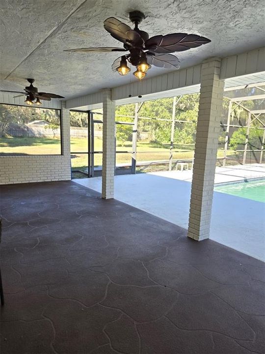 Then through French Doors a Large, Covered, Poolside Lanai