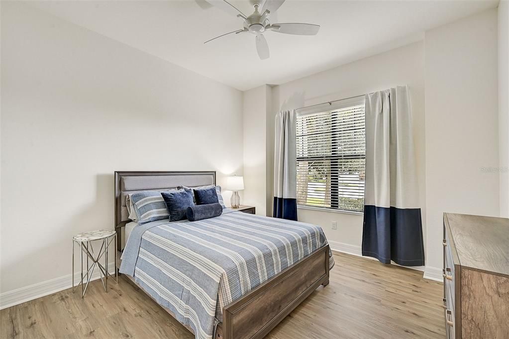 Bedroom #2 with LVP flooring. Queen-size bed.