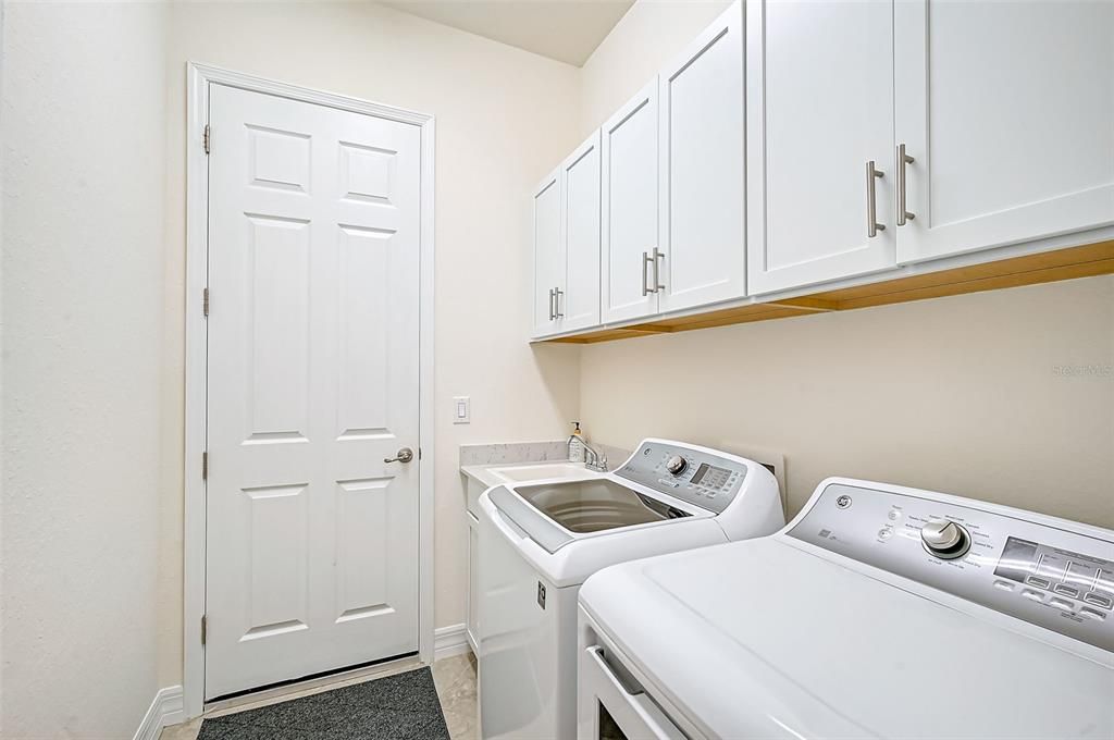 Laundry room w/ sink. Door to 3 car garage. Don't miss tankless water heater.