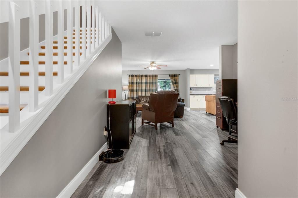 View from front door- half bath to the right and stairs to the right.