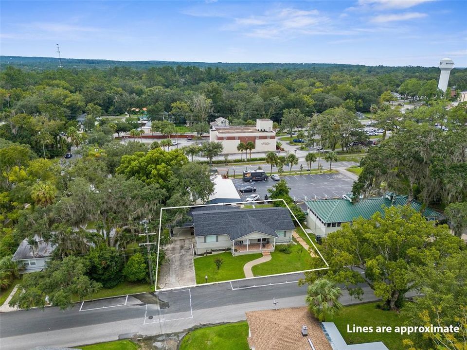 View of the front of the building from 290 E Fort Dade Ave. Street parking, driveway, and carport parking.