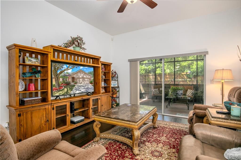 Family room has wood floors and sliders to the screened lanai.