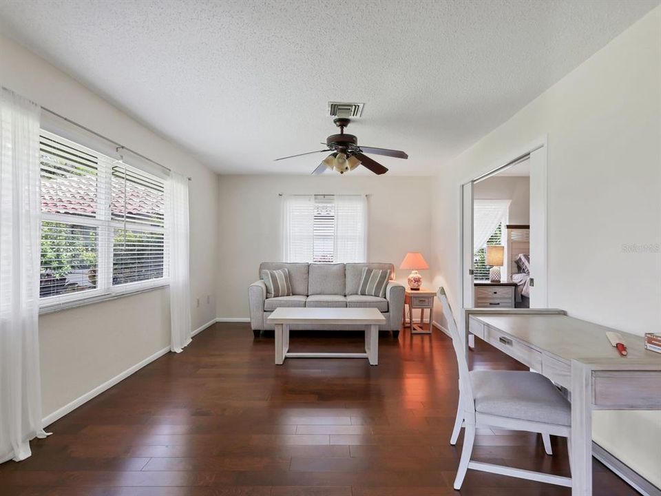 engineered mahogany wood floor seamlessly continue in Den