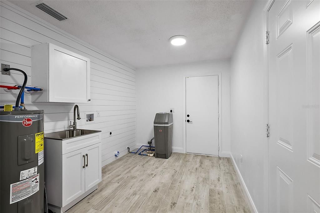 Laundry room; door ahead leads to the carport; door to the right to the garage