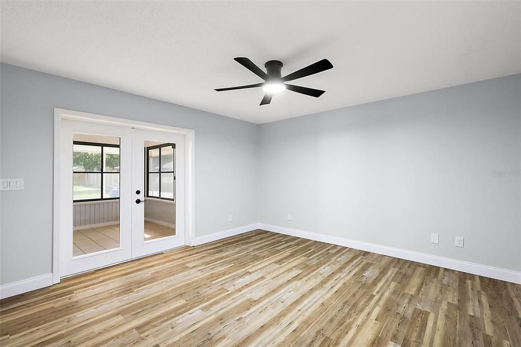 Primary bedroom with French doors to the lanai/pool