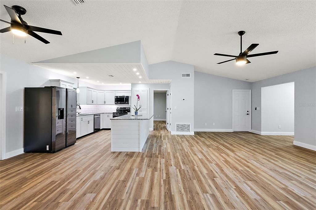 Great open space, with the owner's suite straight ahead; door to the right leads to the laundry room, garage and carport.