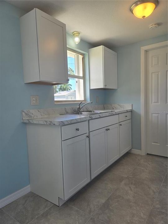 Kitchen with window looking out to back yard