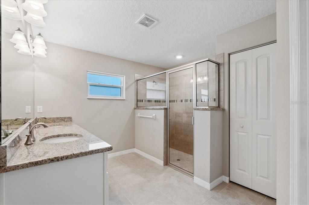 Master bathroom with double granite vanity sinks and large walk-in shower