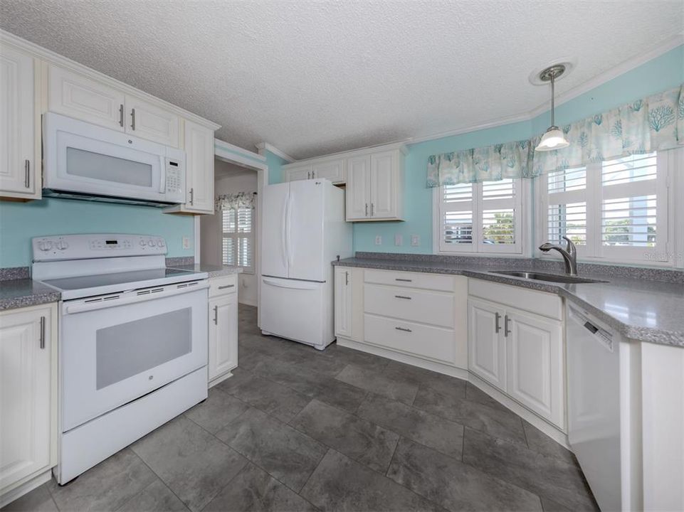 Kitchen with granite counters, soft close cabinets, stainless sink and updated appliances.