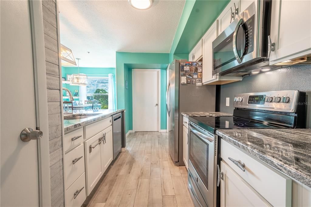 The kitchen features soft close cabinets and drawers, with undermount lighting as well as a closet pantry.