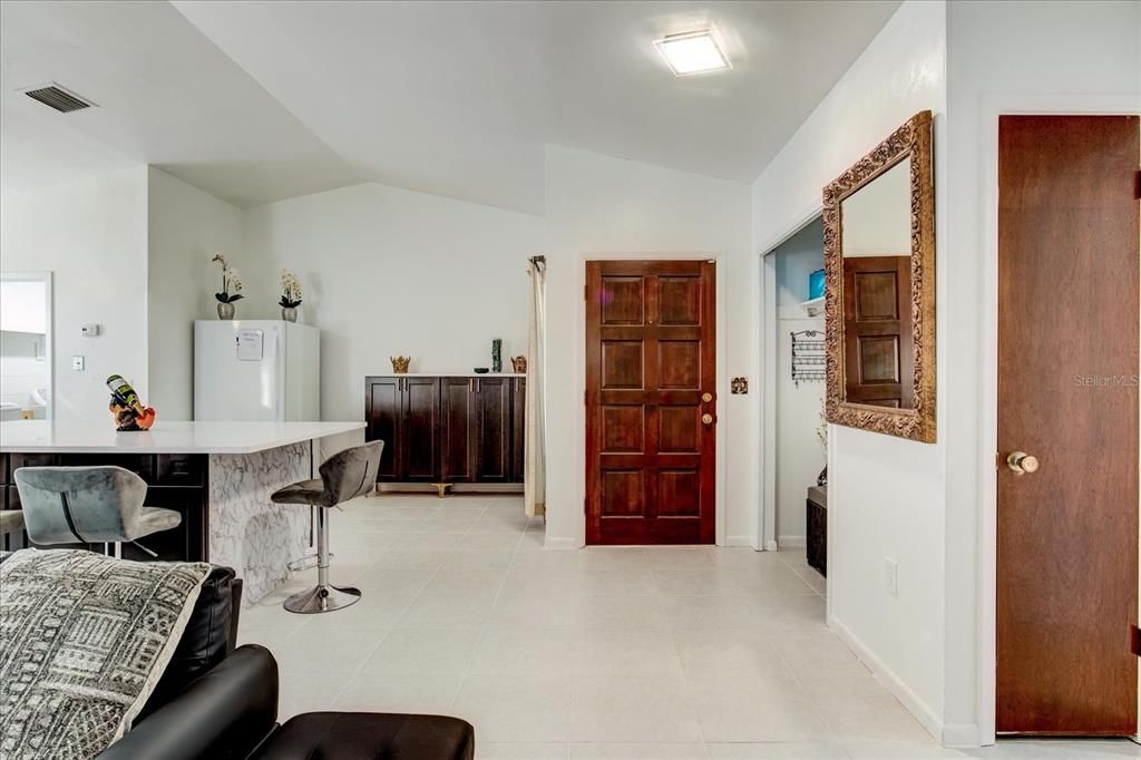 Front door opens to foyer, kitchen and living areas.