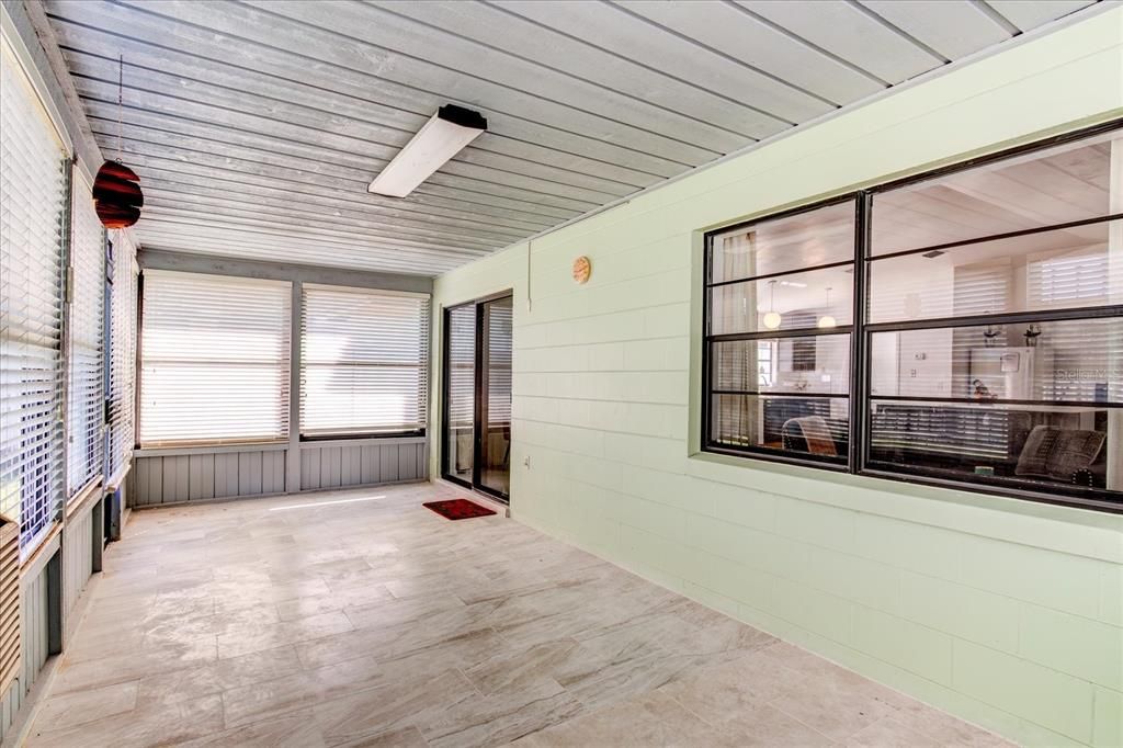 Oversized back porch with new flooring.