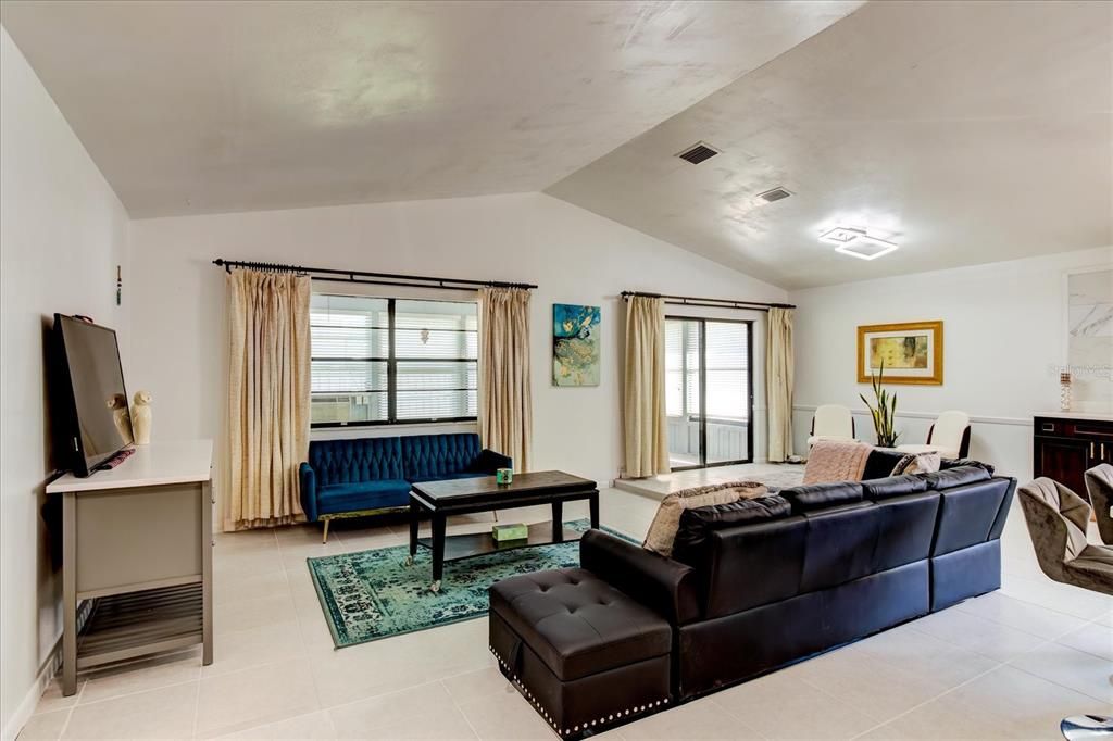 Large living room area leading out to outdoor porch.