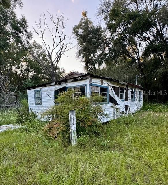 SIDE OF HOUSE NEEDS REPAIR