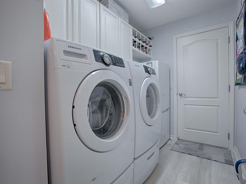 Laundry Room With Cabinets and Wine Rack