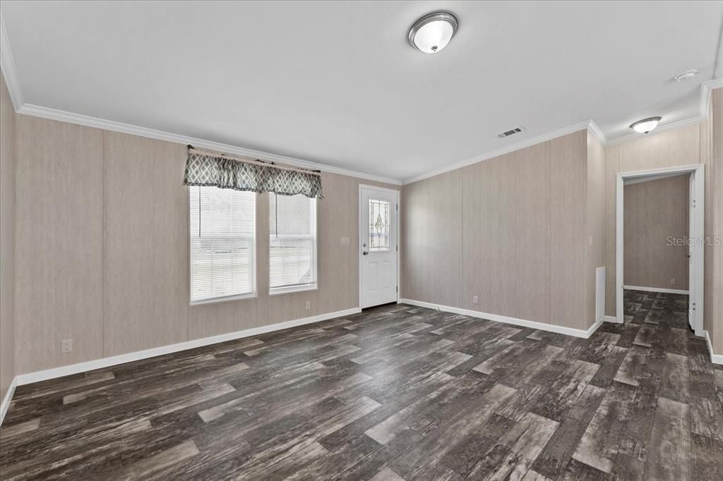 Living room w/view of primary bedroom entry