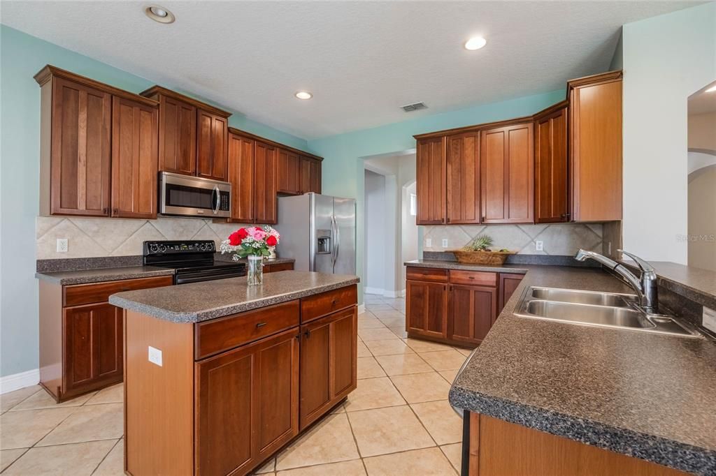 Kitchen fully equipped with appliances and prep island.